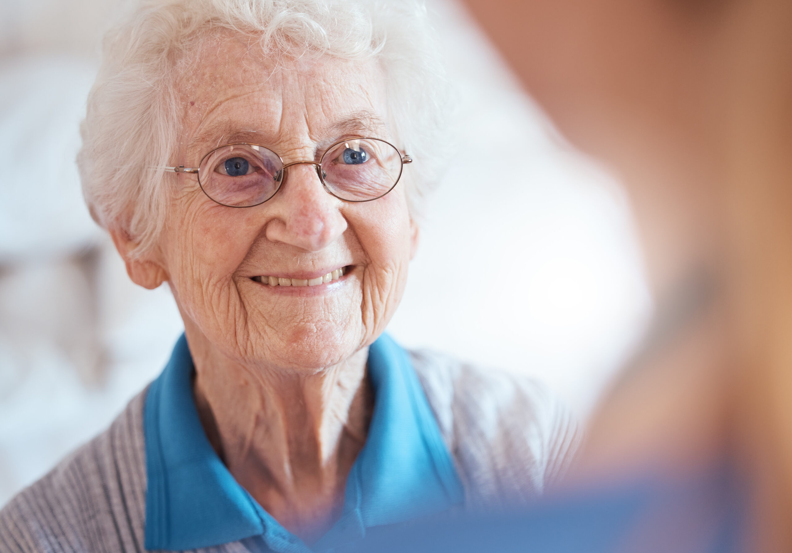 Elderly woman smiling after a home eye test with a mobile optician in Sheffield.